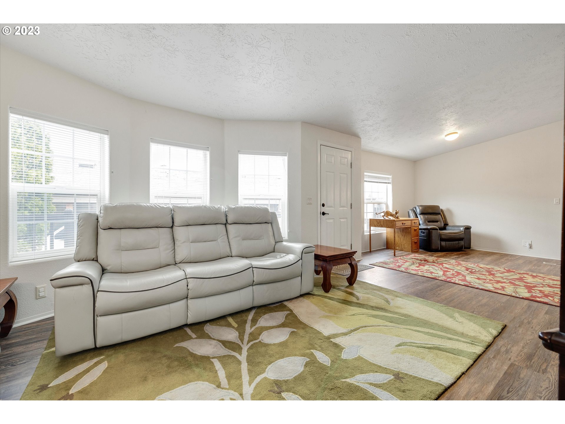 1949 Southeast Palmquist Road, Unit 17 Gresham, OR 97080 - Photo 5 of 31 a living room with furniture and a rug