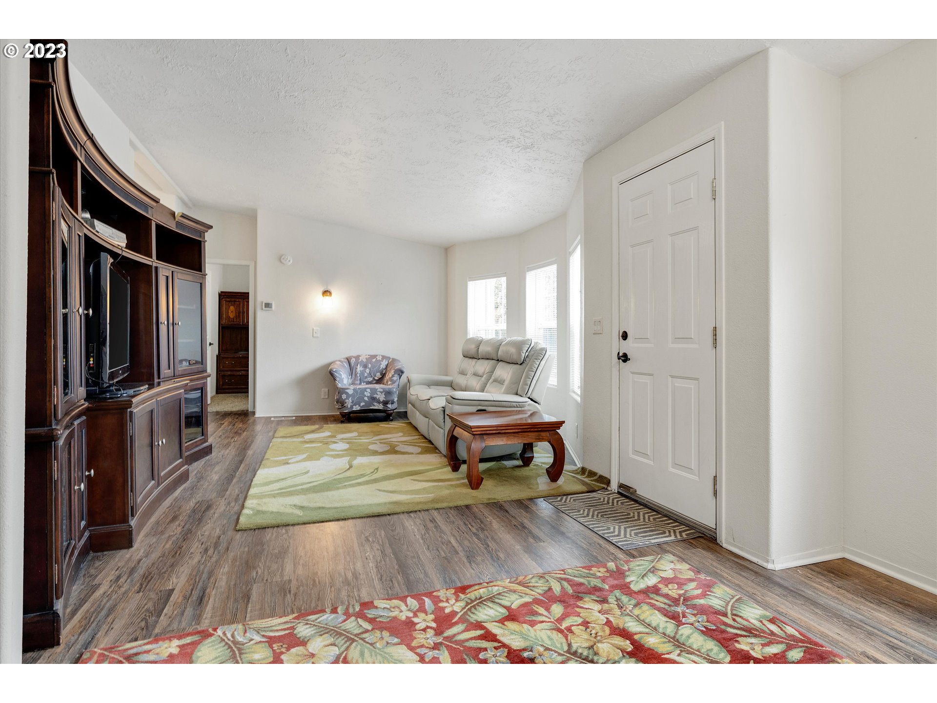 1949 Southeast Palmquist Road, Unit 17 Gresham, OR 97080 - Photo 6 of 31 a living room with furniture and a flat screen tv