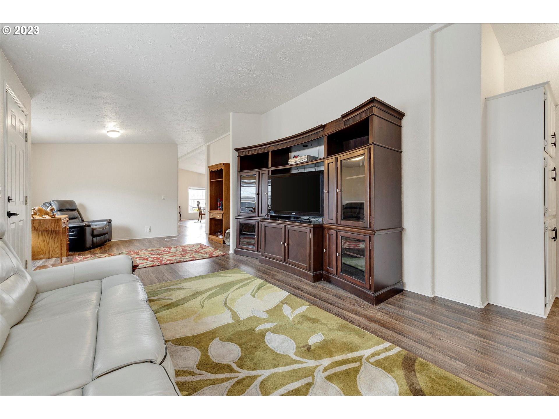 1949 Southeast Palmquist Road, Unit 17 Gresham, OR 97080 - Photo 8 of 31 a living room with furniture and a flat screen tv