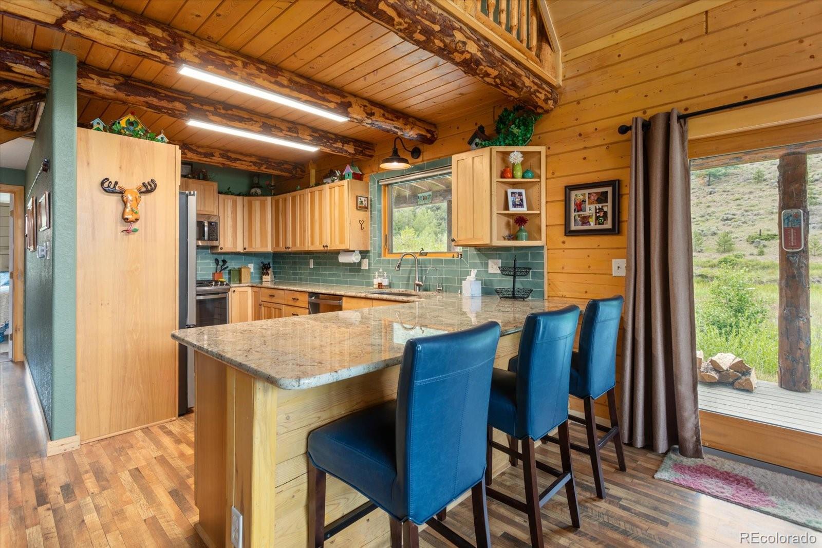 1021 Silver Lakes Road Villa Grove, CO 81155 - Photo 16 of 50 a kitchen with a table chairs and refrigerator