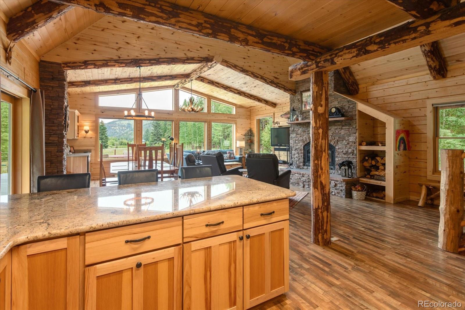 1021 Silver Lakes Road Villa Grove, CO 81155 - Photo 18 of 50 a kitchen with stainless steel appliances granite countertop a sink and wooden cabinets