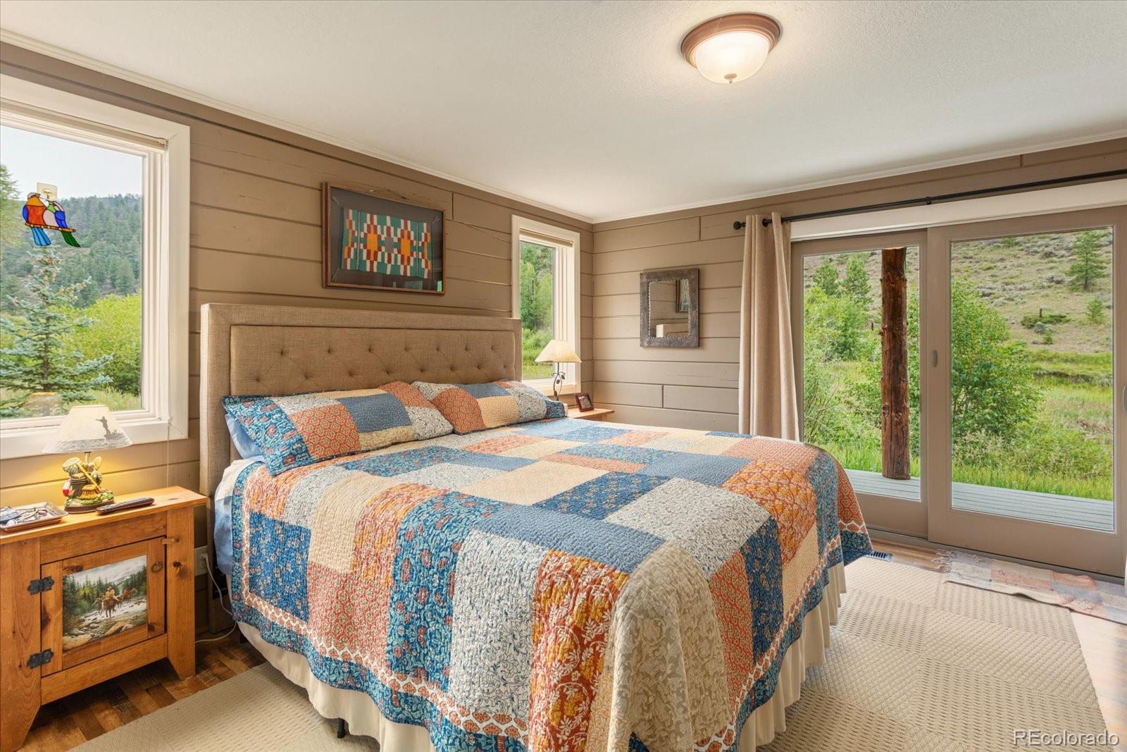 1021 Silver Lakes Road Villa Grove, CO 81155 - Photo 19 of 50 a bedroom with a bed and a large window