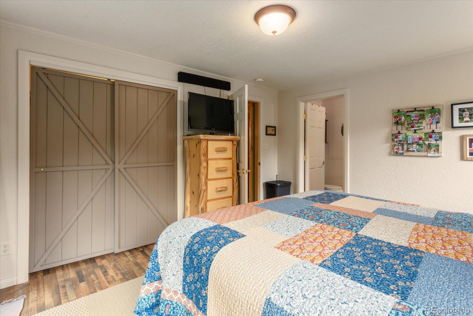 1021 Silver Lakes Road Villa Grove, CO 81155 - Photo 20 of 50 a bedroom with a bed and a television