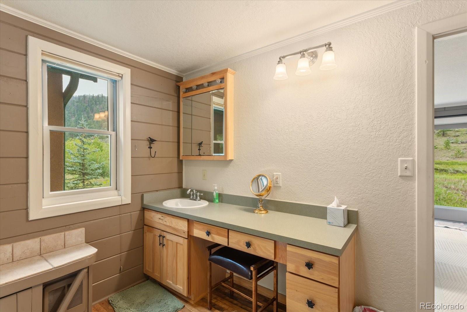 1021 Silver Lakes Road Villa Grove, CO 81155 - Photo 22 of 50 a bathroom with a sink and a mirror