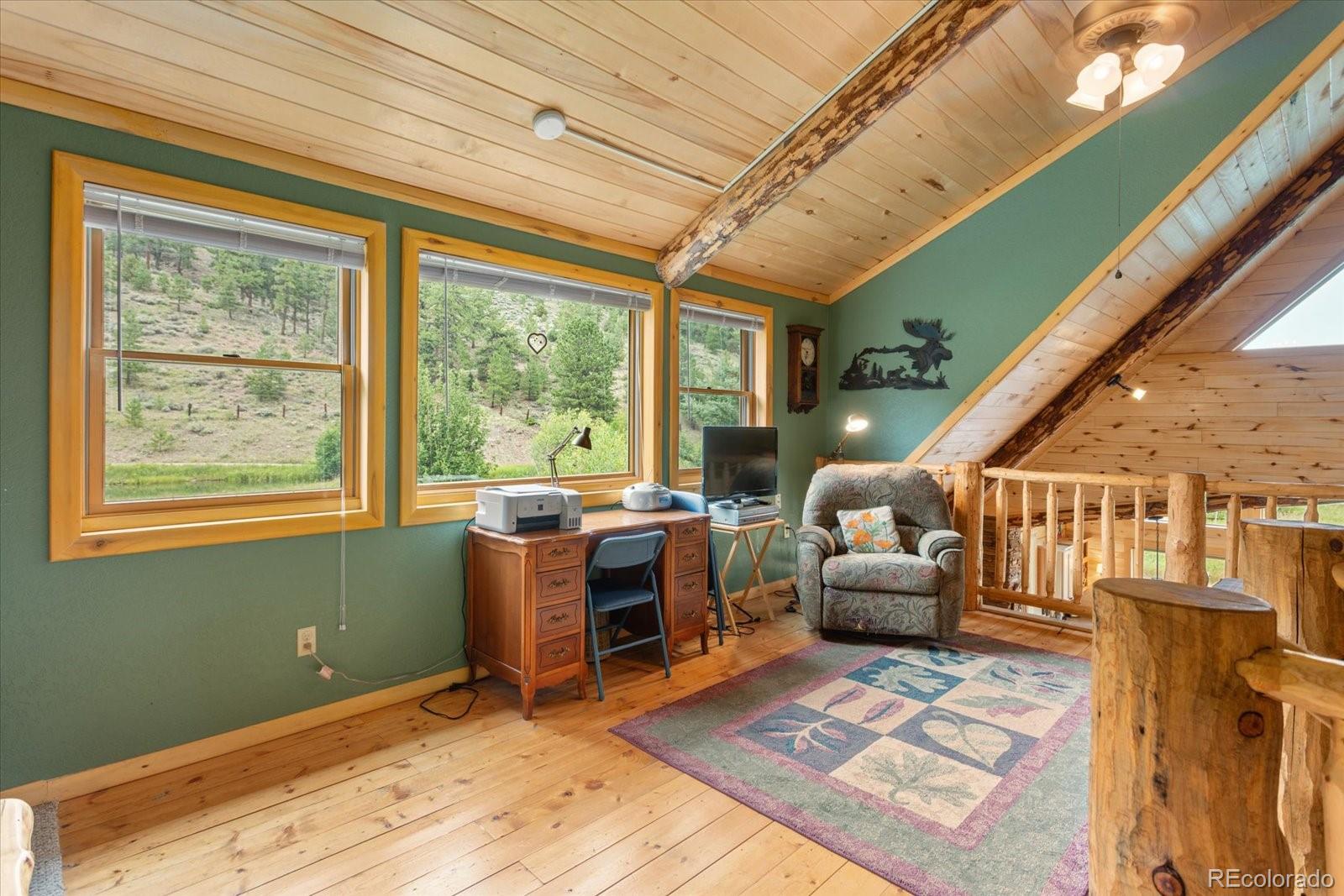 1021 Silver Lakes Road Villa Grove, CO 81155 - Photo 26 of 50 a living room with furniture and a window
