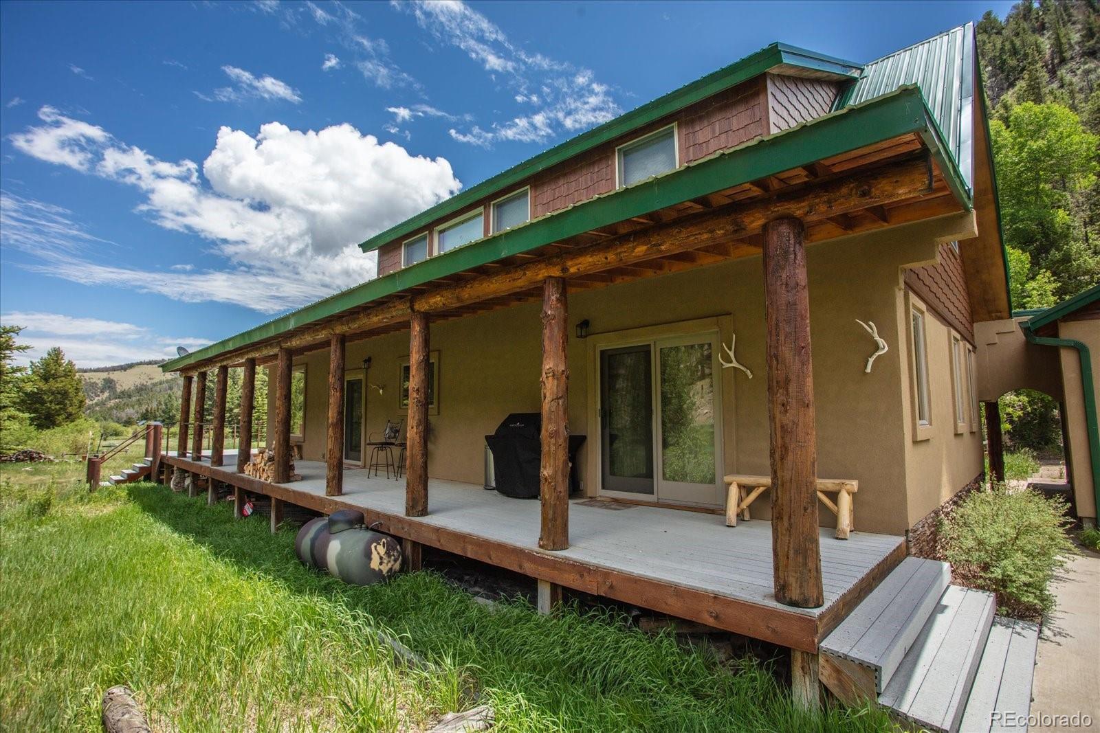 1021 Silver Lakes Road Villa Grove, CO 81155 - Photo 39 of 50 a view of a house with backyard and porch