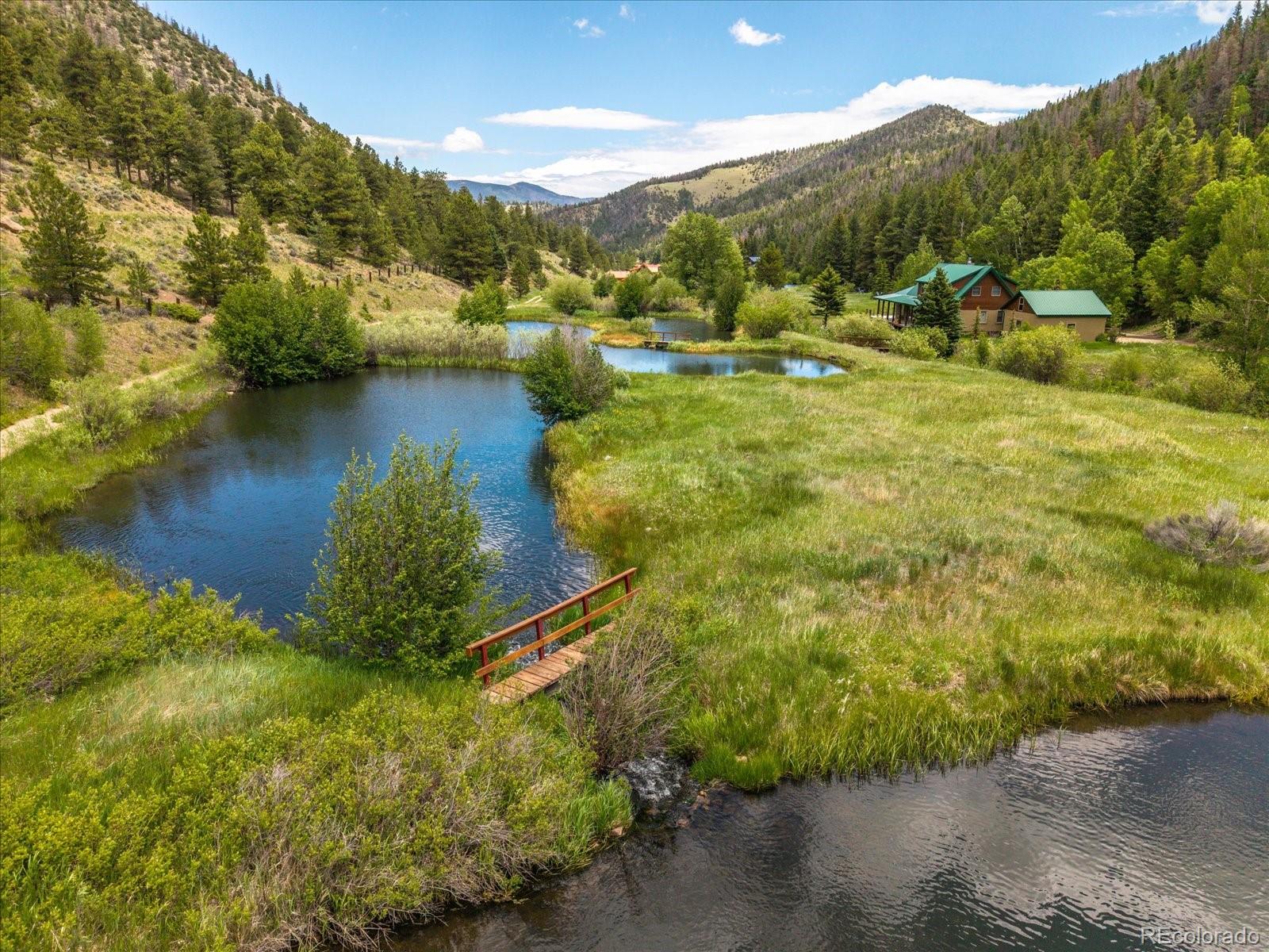 1021 Silver Lakes Road Villa Grove, CO 81155 - Photo 47 of 50 a view of a lake with mountains in the background
