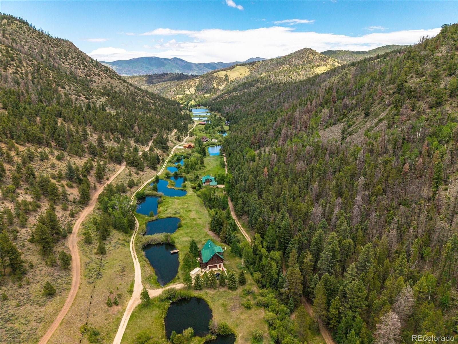 1021 Silver Lakes Road Villa Grove, CO 81155 - Photo 49 of 50 a view of a lush green hillside and houses