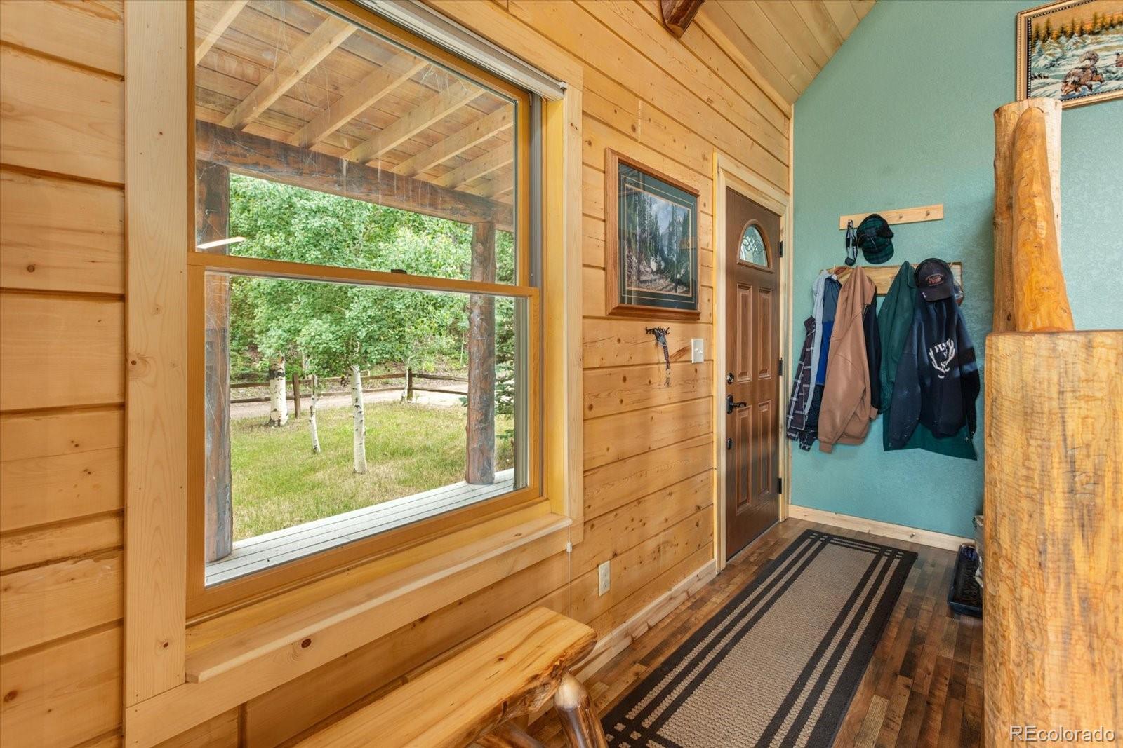 1021 Silver Lakes Road Villa Grove, CO 81155 - Photo 7 of 50 a view of a balcony with wooden floor and furniture