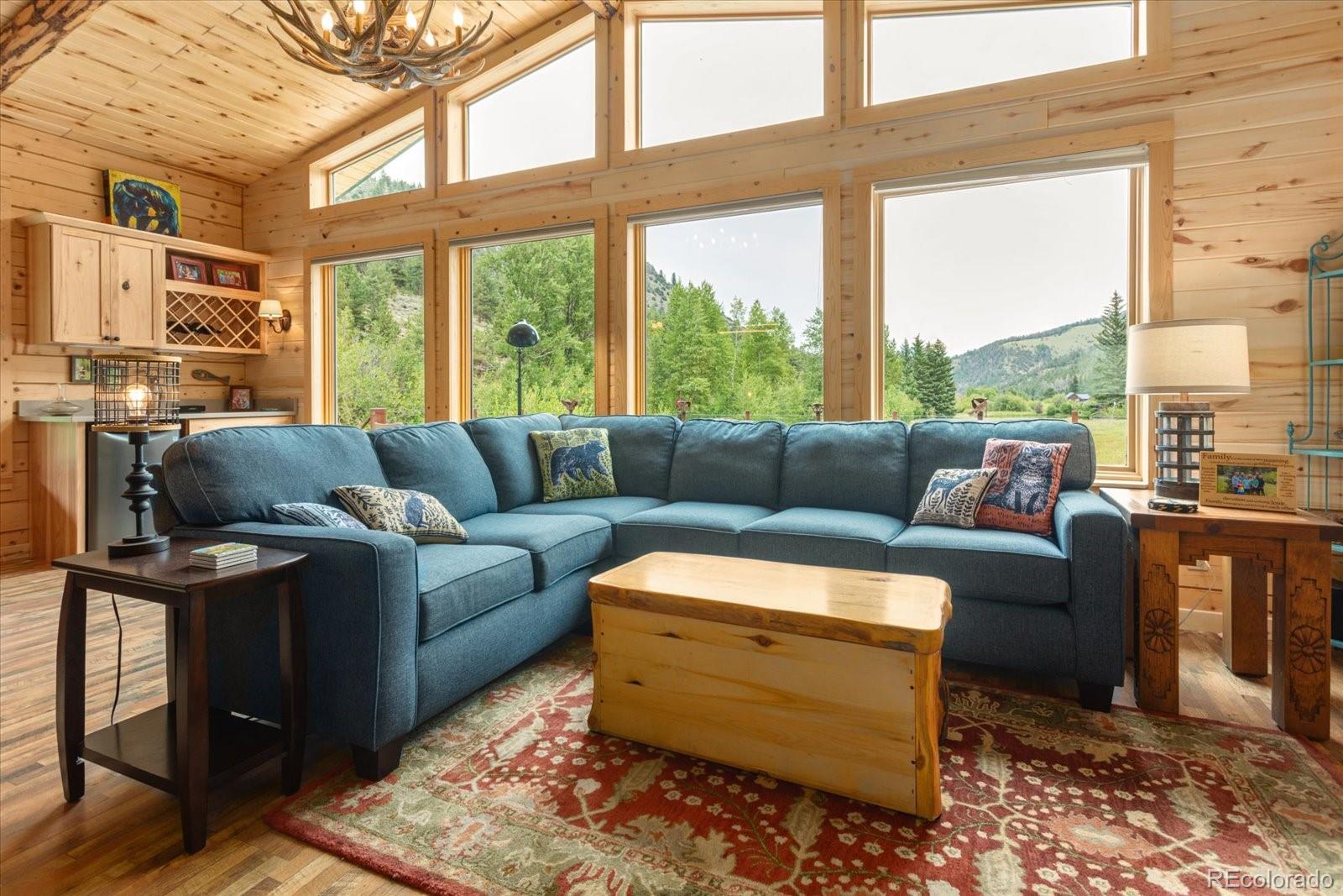 1021 Silver Lakes Road Villa Grove, CO 81155 - Photo 9 of 50 a living room with furniture and a floor to ceiling window