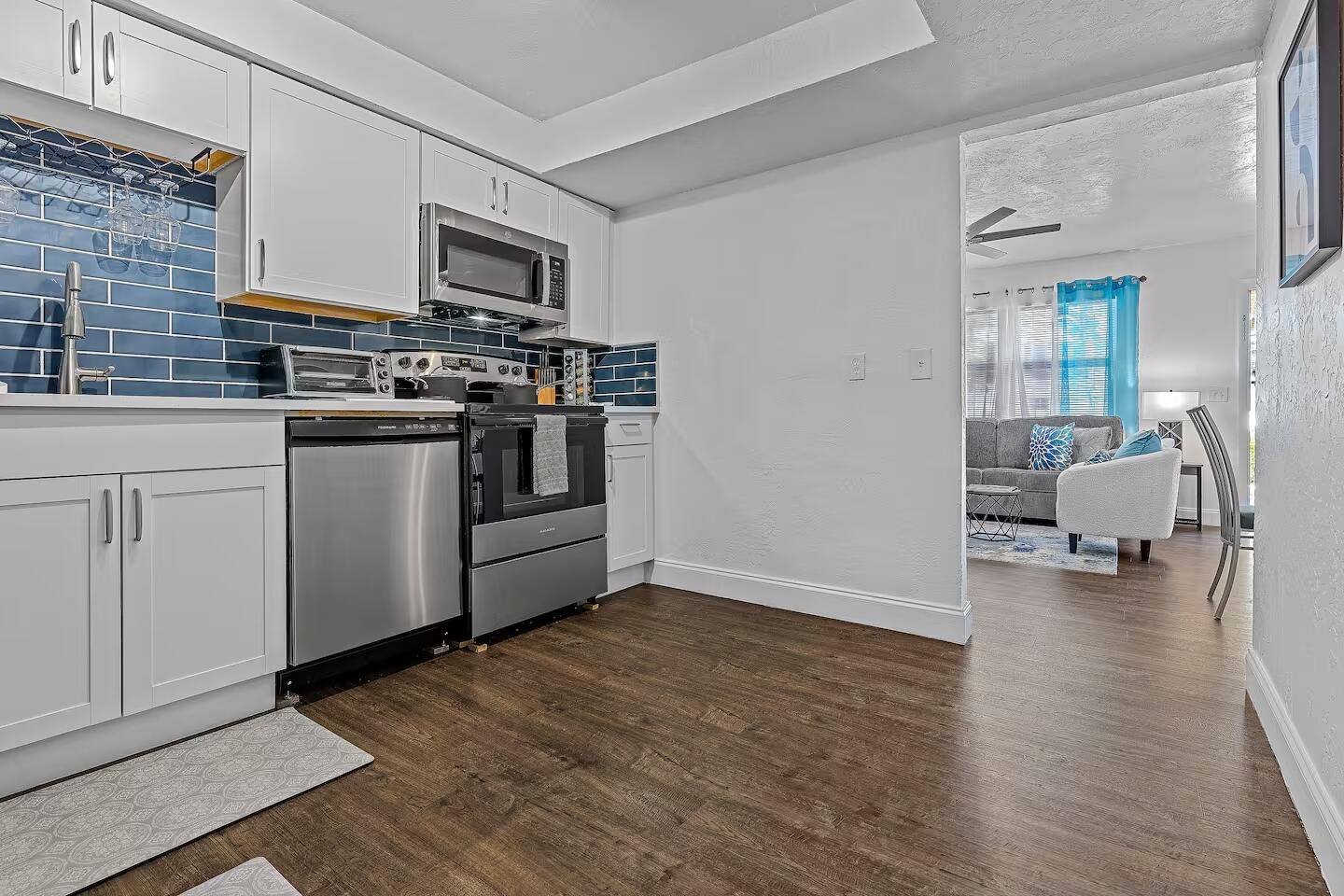 101 Northeast 4th Street, Unit 2 Delray Beach, FL 33444 - Photo 12 of 13 a kitchen with stainless steel appliances and wooden floor