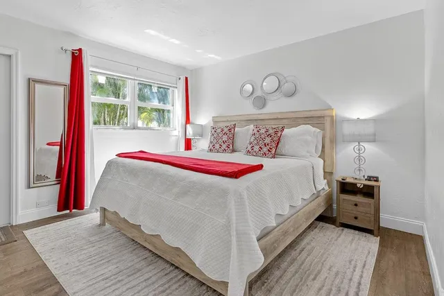 a bed sitting in a bedroom next to a window