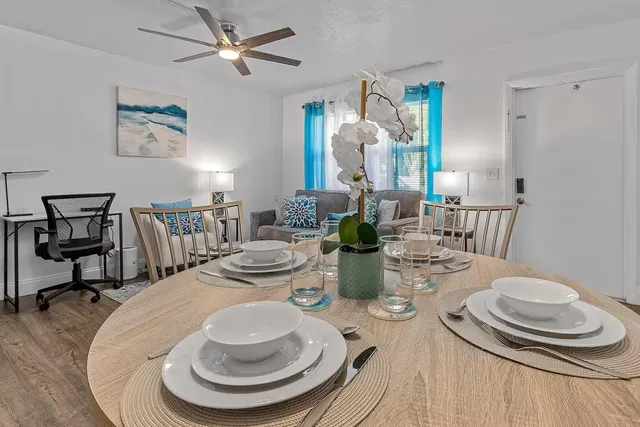 a dining room with furniture a rug and wooden floor
