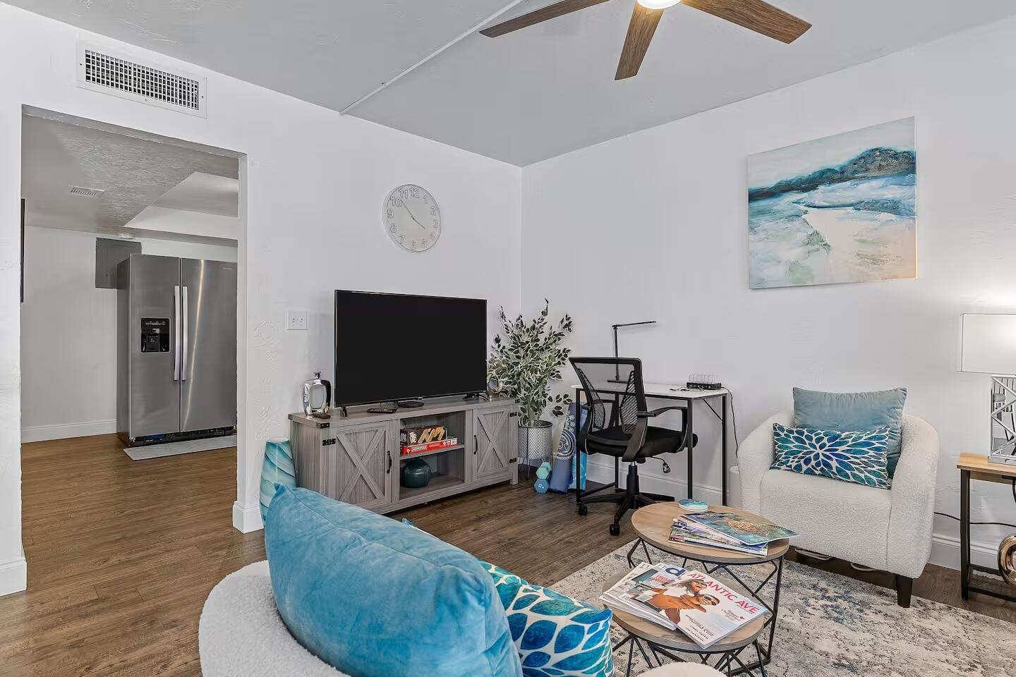 101 Northeast 4th Street, Unit 2 Delray Beach, FL 33444 - Photo 9 of 13 a living room with furniture and a flat screen tv