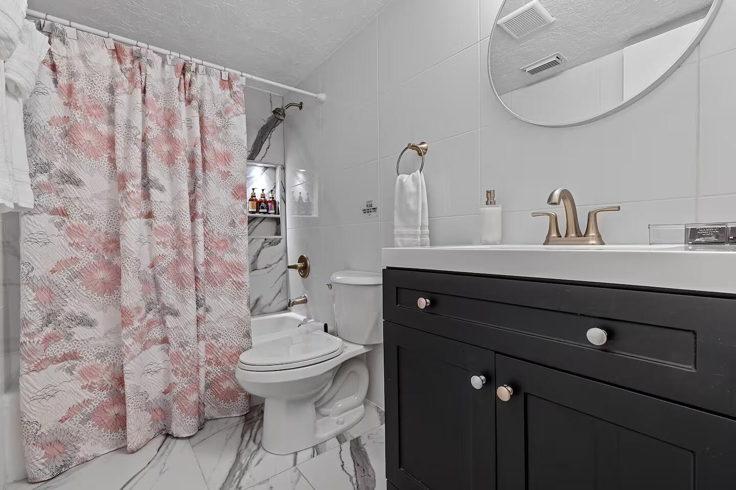 101 Northeast 4th Street, Unit 2 Delray Beach, FL 33444 - Photo 10 of 13 a bathroom with a granite countertop sink a toilet and a mirror