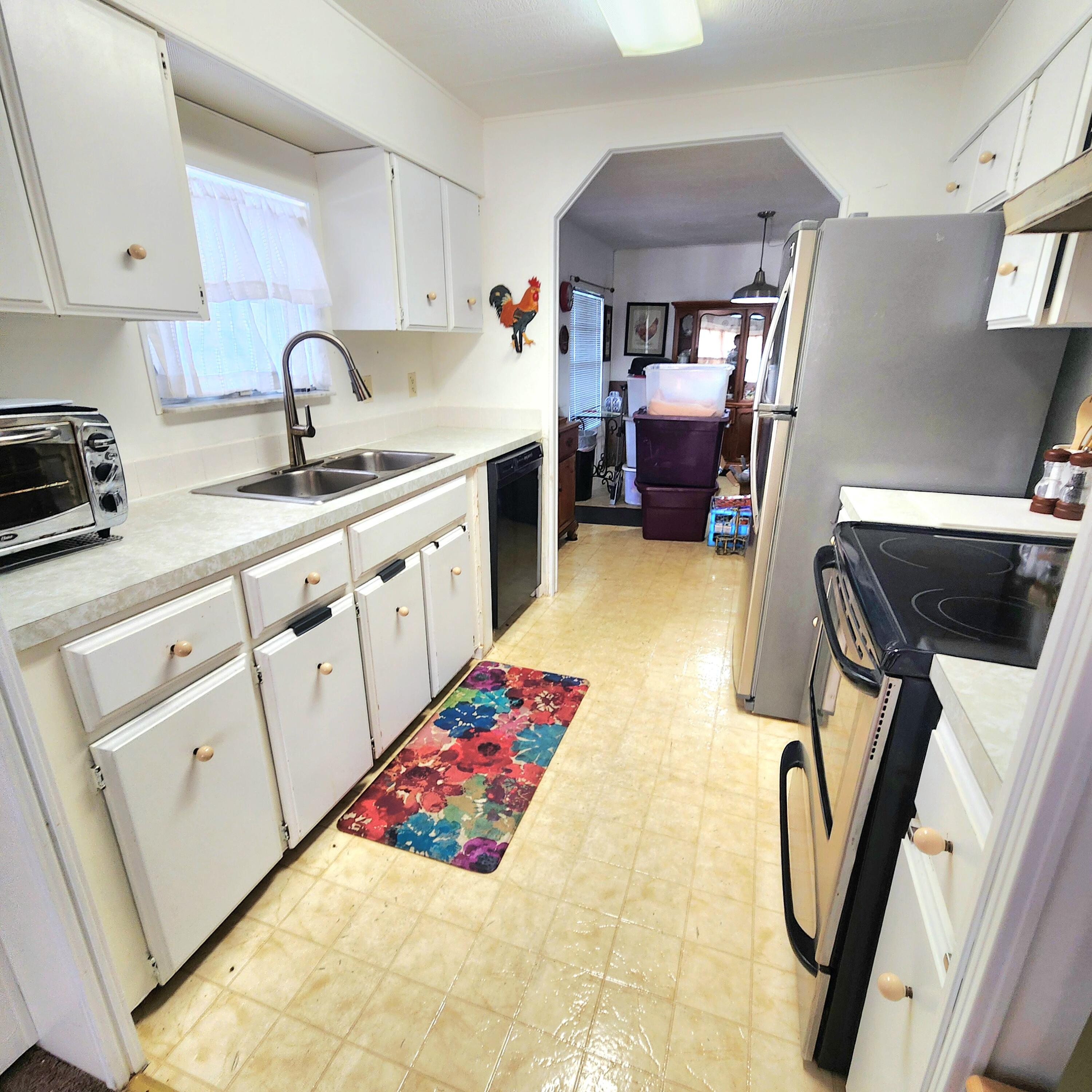 98 Camino Del Rio Port St. Lucie, FL 34952 - Photo 23 of 60 a kitchen with furniture a sink and a refrigerator