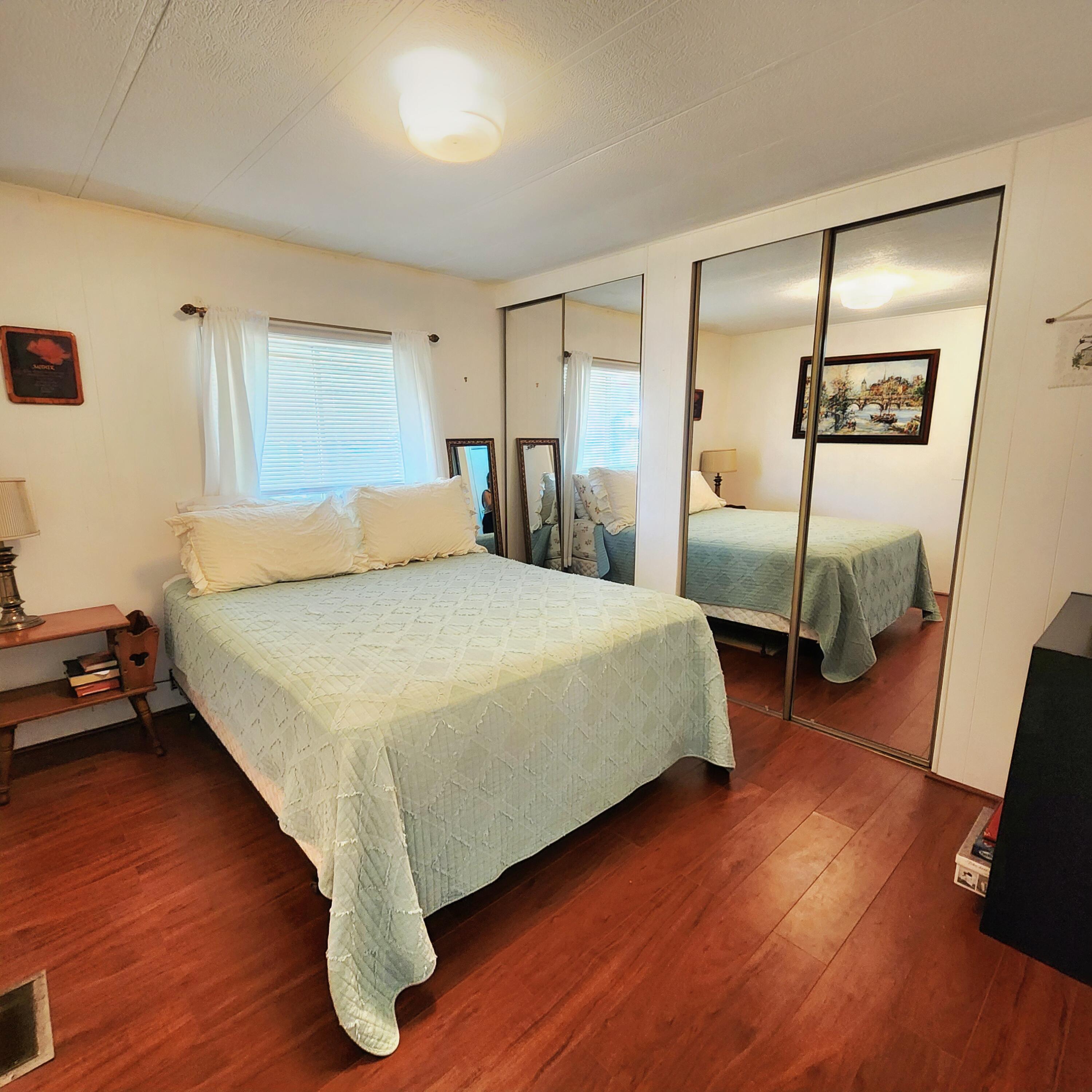 98 Camino Del Rio Port St. Lucie, FL 34952 - Photo 27 of 60 a bedroom with a bed and wooden floor