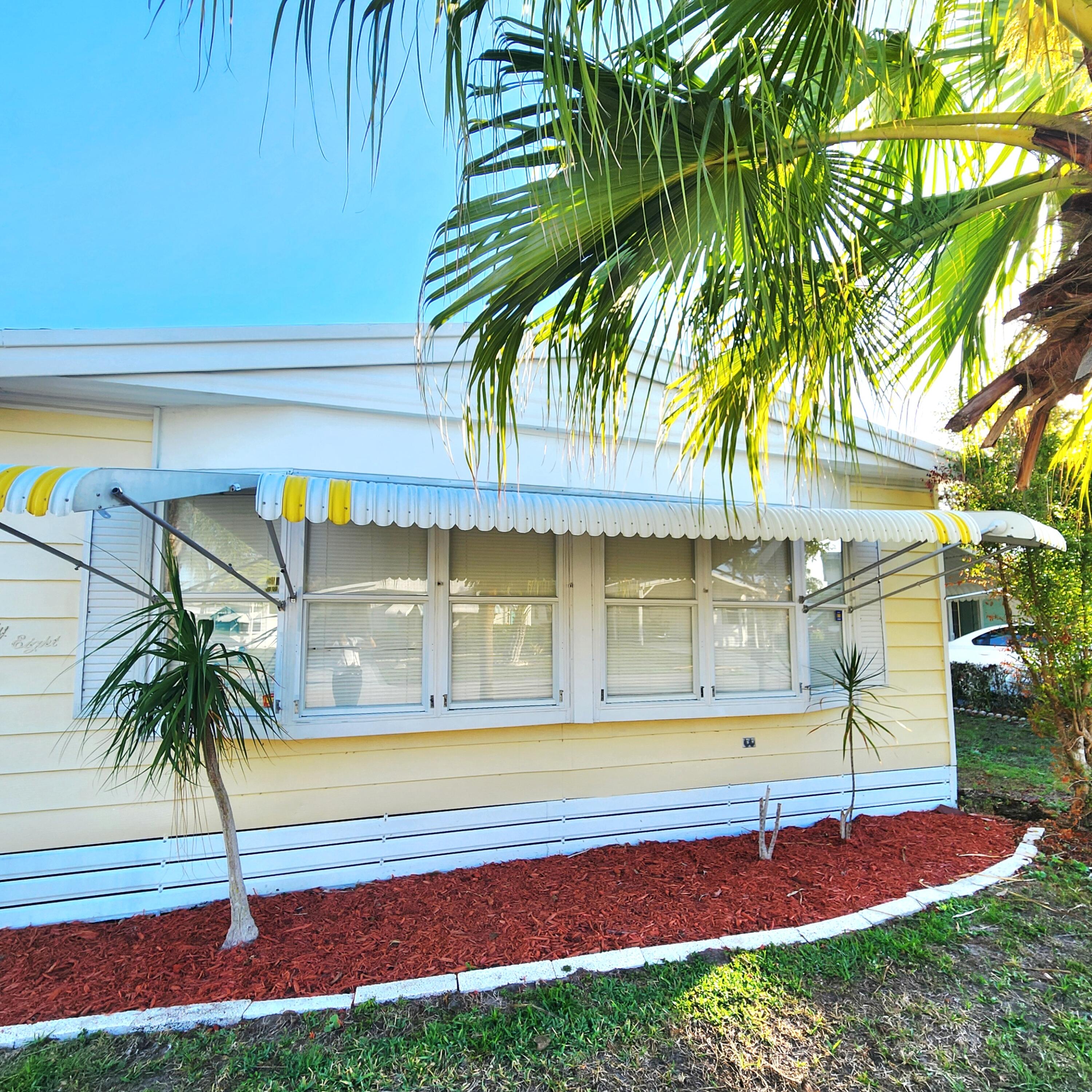 98 Camino Del Rio Port St. Lucie, FL 34952 - Photo 3 of 60 a front view of a house with a yard