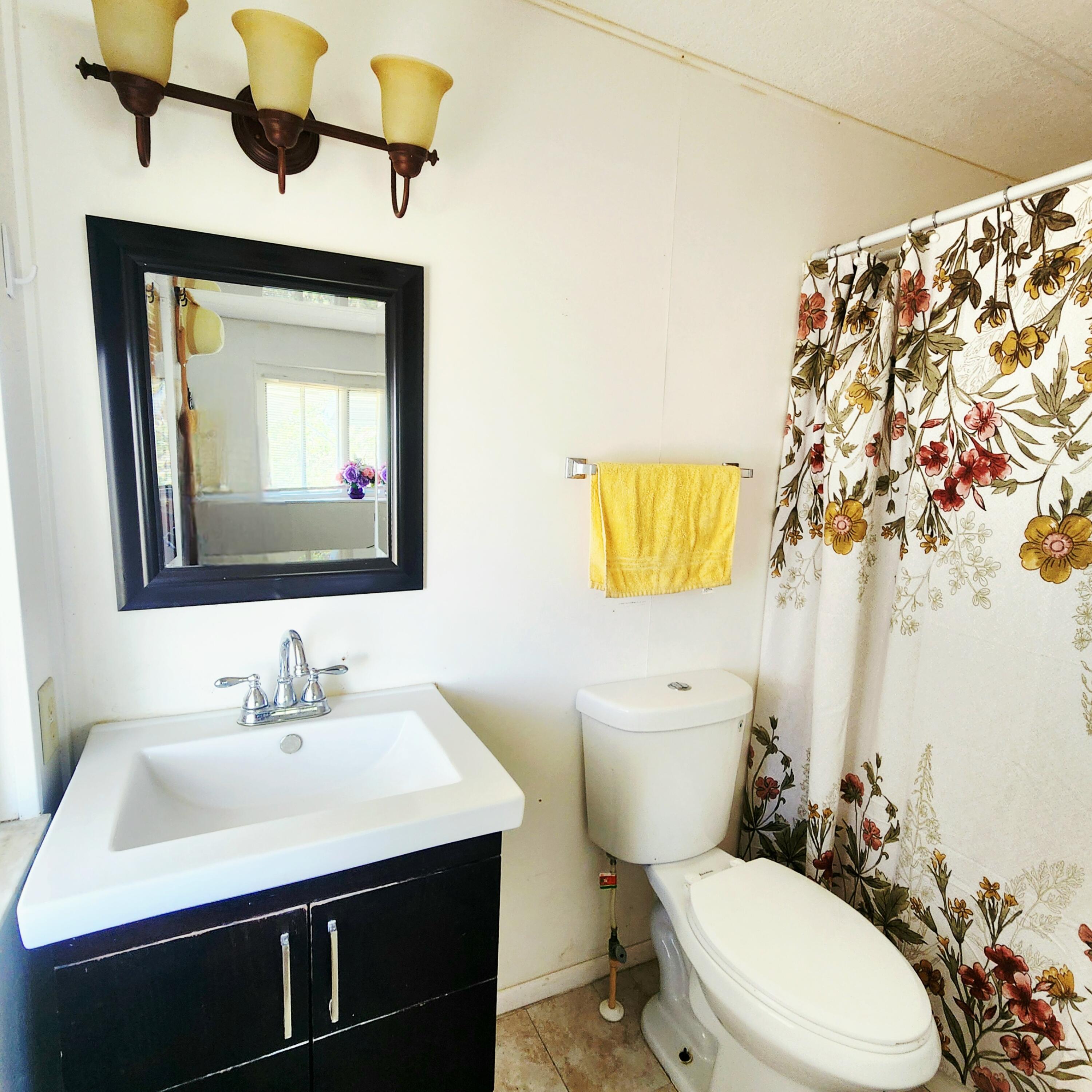 98 Camino Del Rio Port St. Lucie, FL 34952 - Photo 35 of 60 a bathroom with a sink toilet and mirror