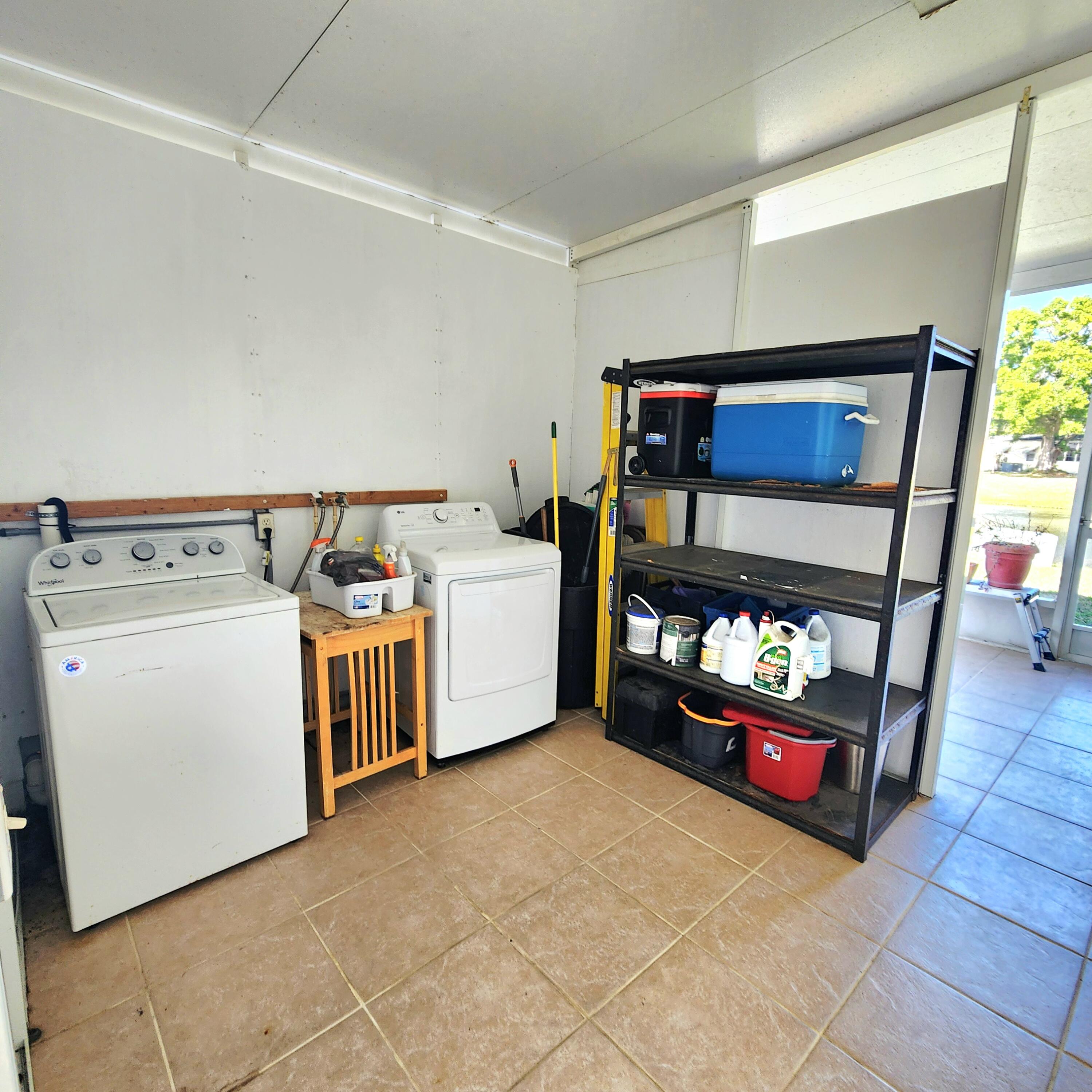 98 Camino Del Rio Port St. Lucie, FL 34952 - Photo 42 of 60 a utility room with dryer and washer