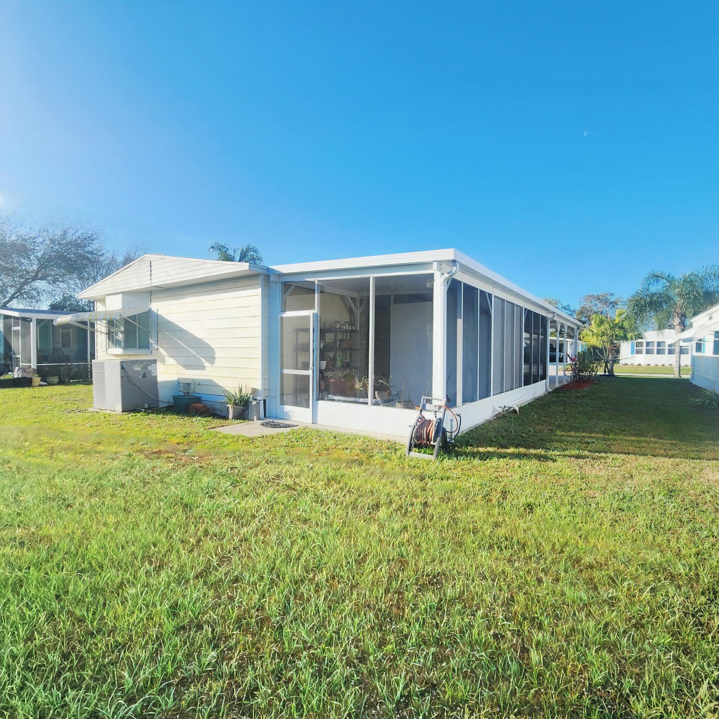 98 Camino Del Rio Port St. Lucie, FL 34952 - Photo 47 of 60 a view of a house with backyard and porch