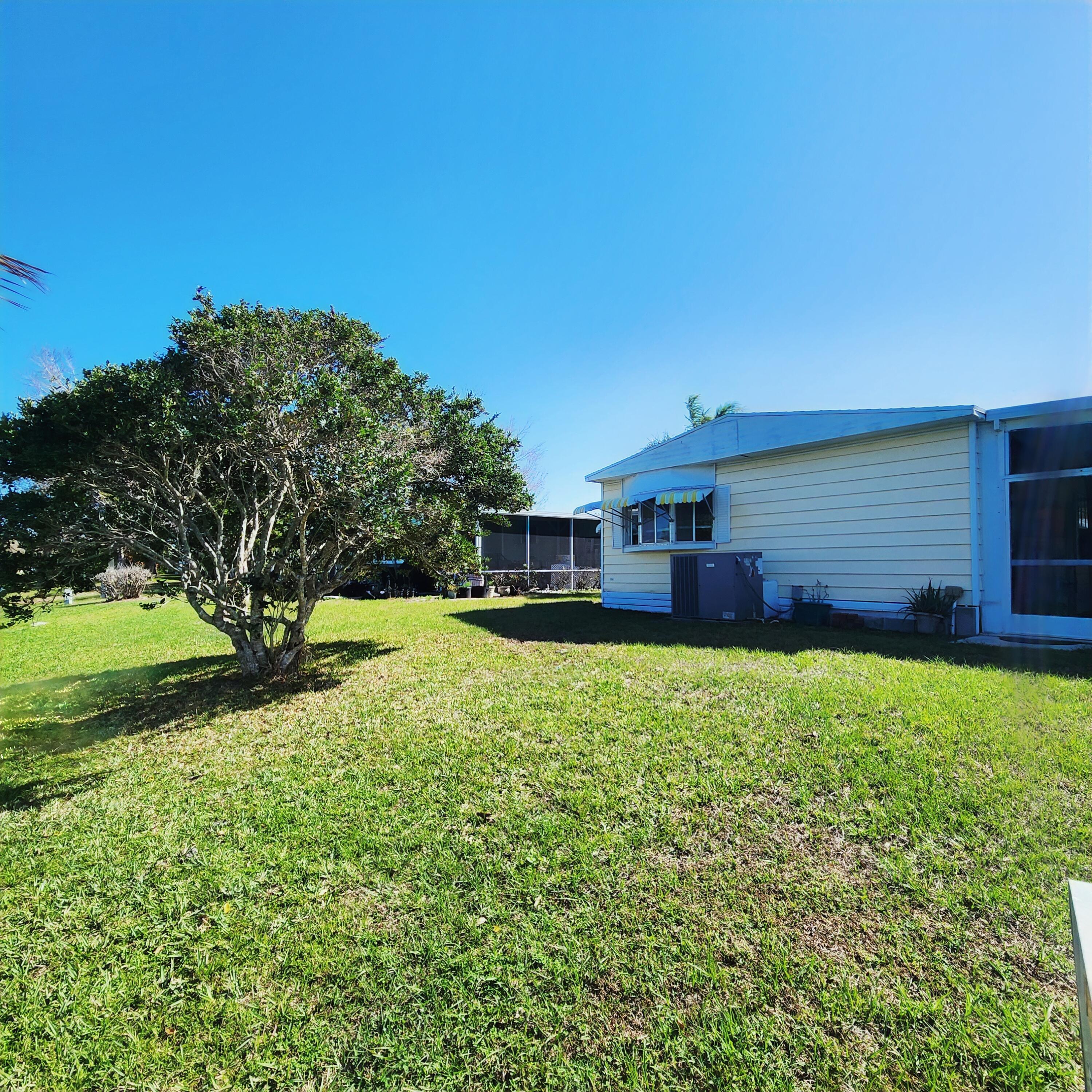 98 Camino Del Rio Port St. Lucie, FL 34952 - Photo 49 of 60 a house view with a garden space