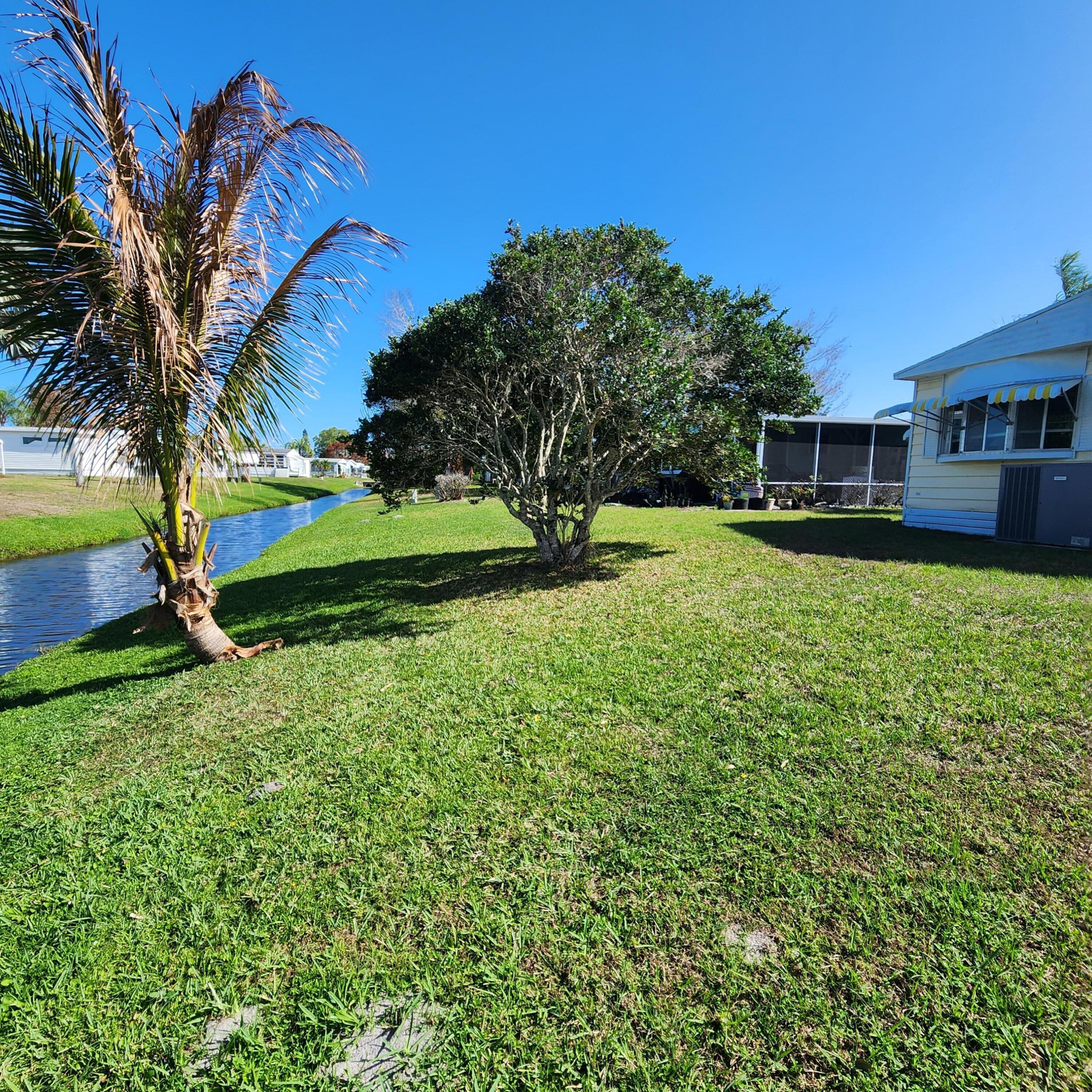98 Camino Del Rio Port St. Lucie, FL 34952 - Photo 50 of 60 a view of a house with a big yard