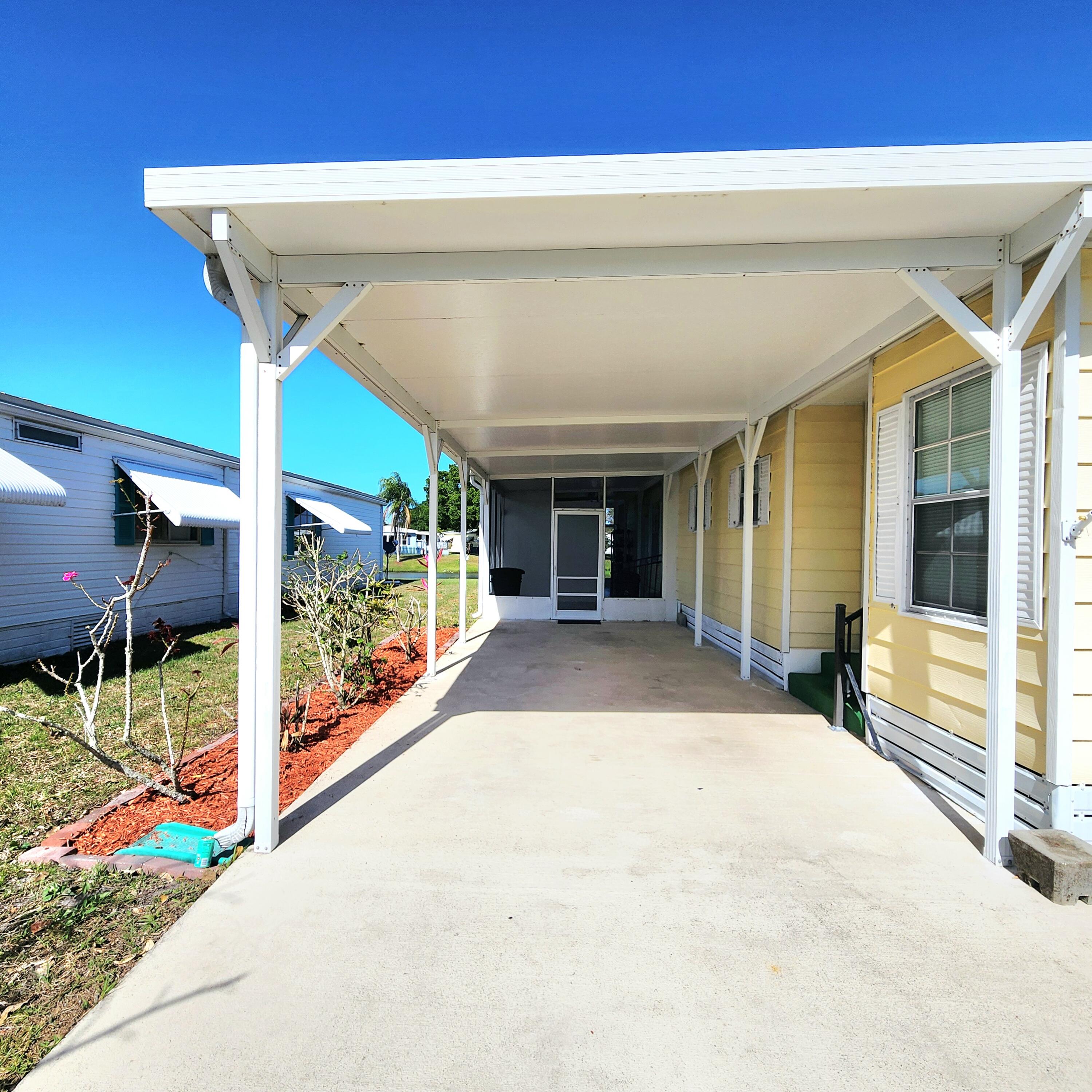 98 Camino Del Rio Port St. Lucie, FL 34952 - Photo 5 of 60 a view of a patio with table and chairs