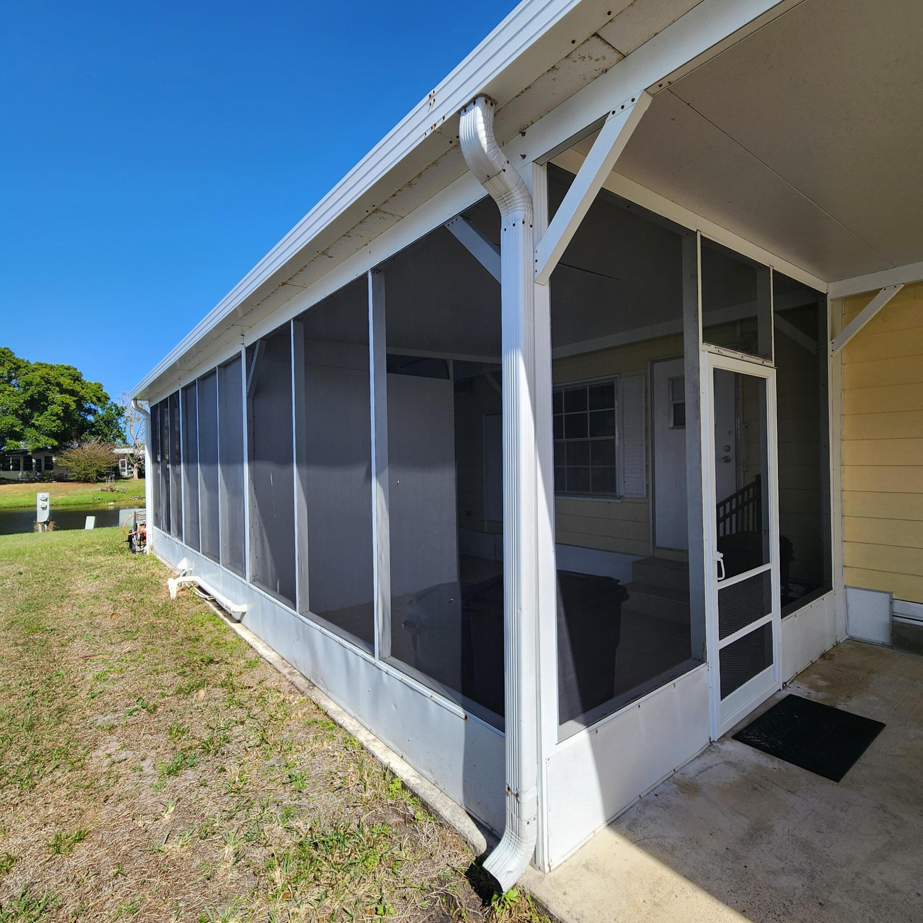 98 Camino Del Rio Port St. Lucie, FL 34952 - Photo 55 of 60 a view of backyard with large tree