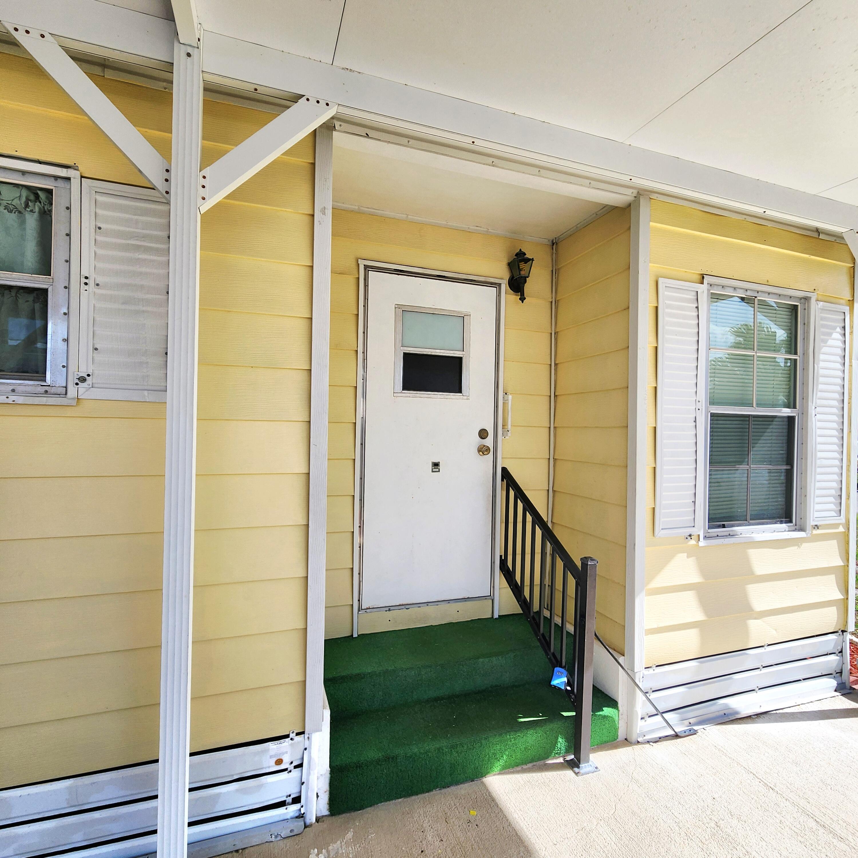 98 Camino Del Rio Port St. Lucie, FL 34952 - Photo 6 of 60 a view of front door of house with a yard