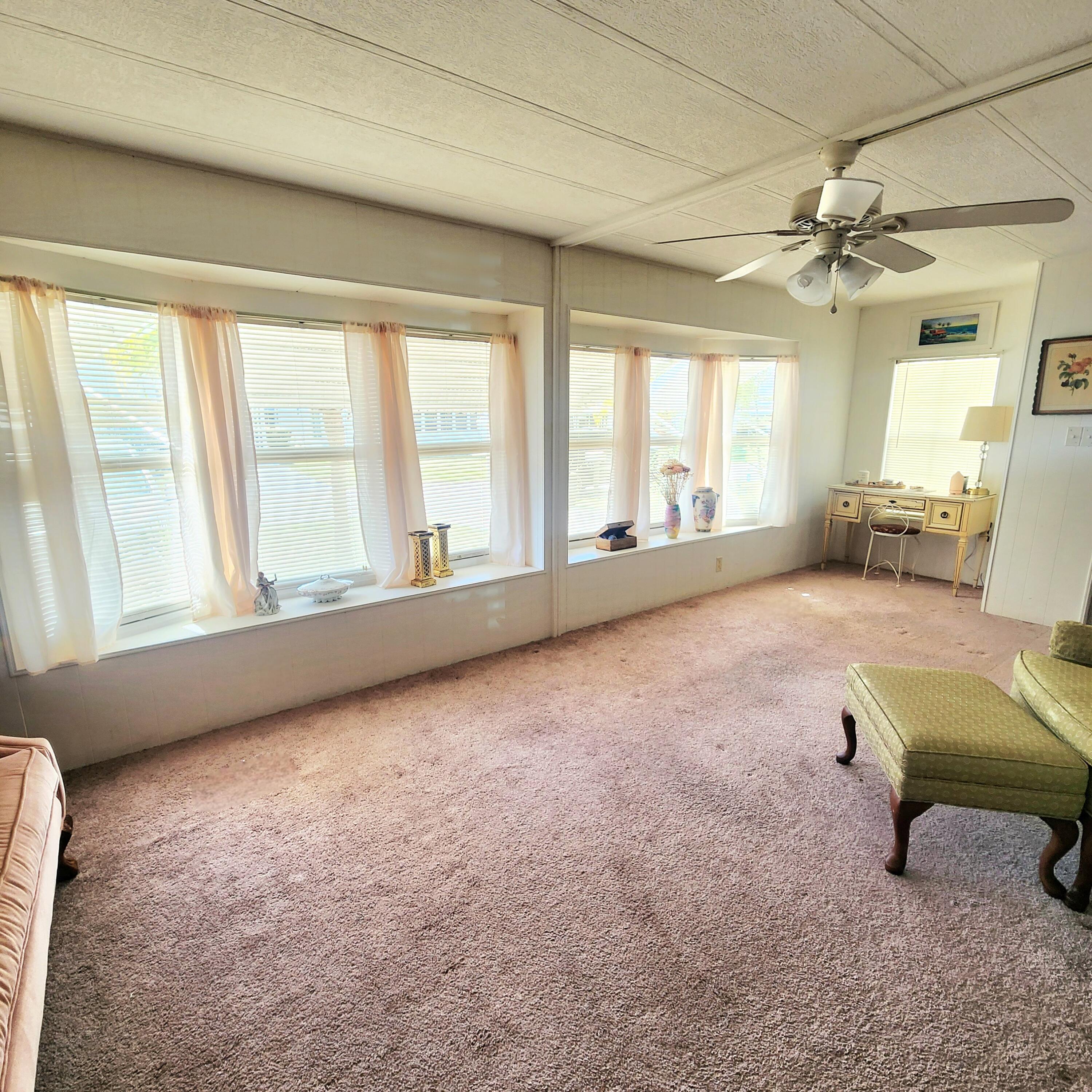98 Camino Del Rio Port St. Lucie, FL 34952 - Photo 8 of 60 a living room with furniture and a window