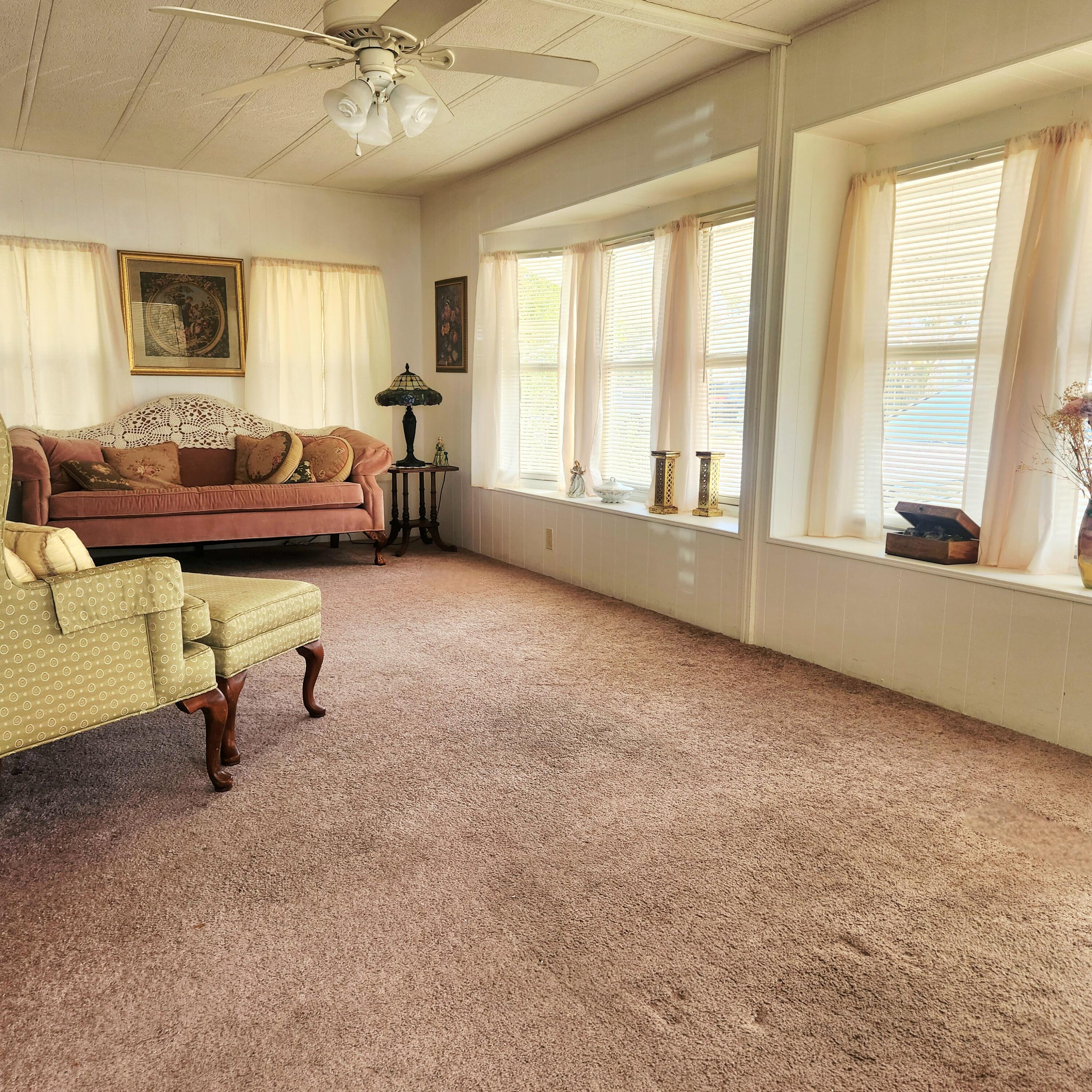 98 Camino Del Rio Port St. Lucie, FL 34952 - Photo 10 of 60 a living room with furniture and a large window