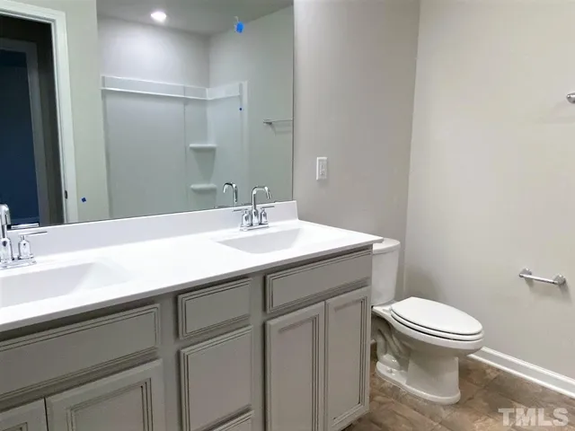 a bathroom with a sink toilet and a mirror