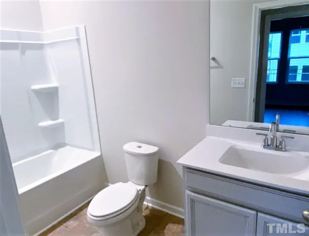 a white toilet sitting next to a bathroom sink