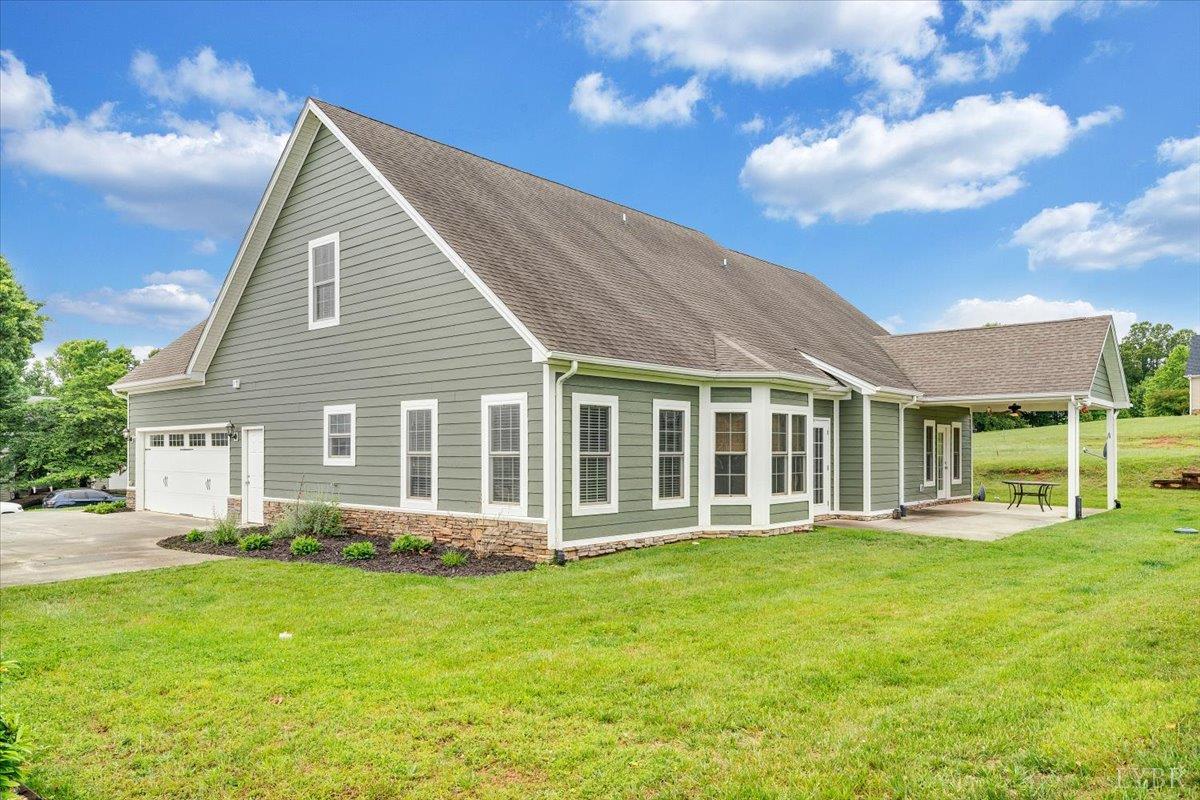 1250 Our Cove Road Huddleston, VA 24104 - Photo 47 of 70 a front view of house with a garden and trees
