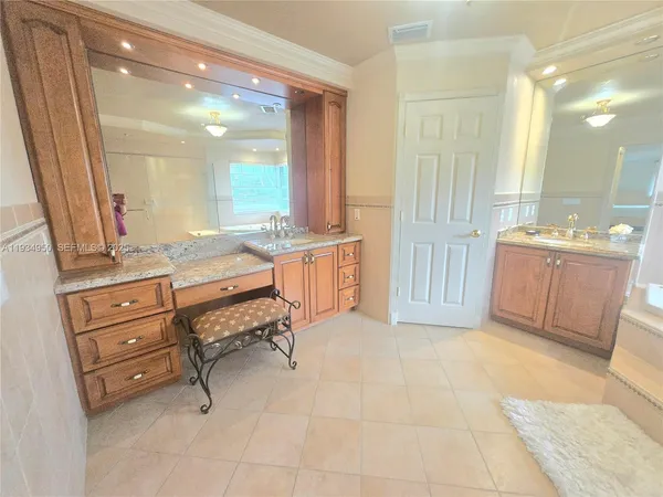 a view of a bedroom with a bed and wooden floor