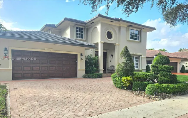 a front view of a house with a yard and garage