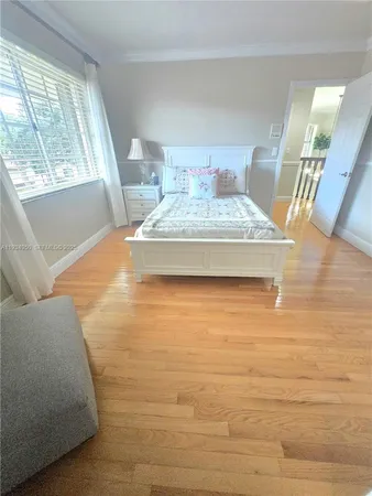 a dining room with furniture a chandelier and wooden floor