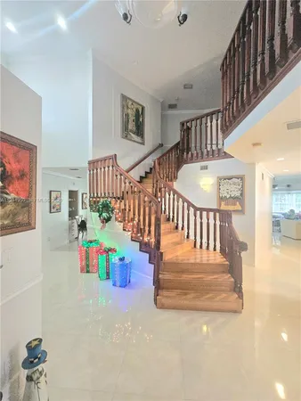 a view of entryway wih livingroom and stairs