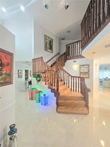 a view of entryway wih livingroom and stairs