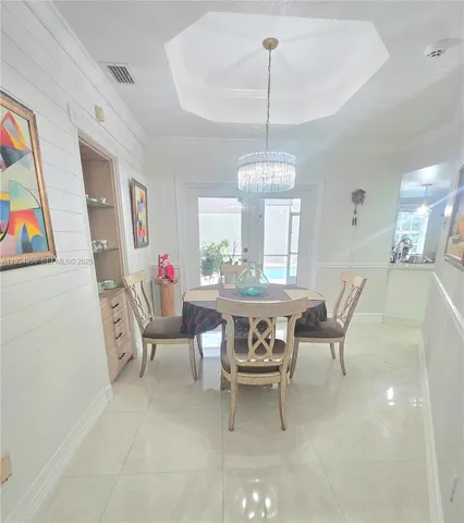 a view of a porch with chairs and backyard