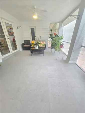 a view of a room with furniture and wooden floor