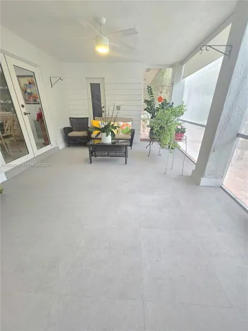a view of a room with furniture and wooden floor