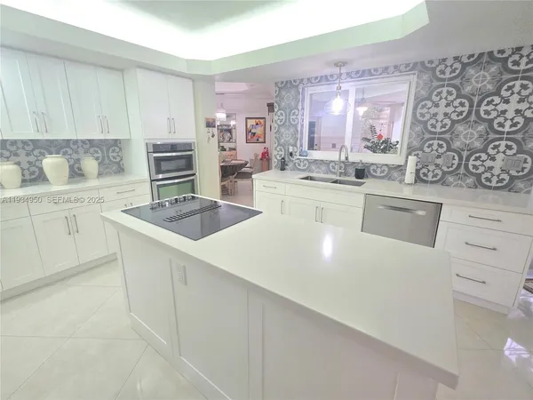 a kitchen with stainless steel appliances a white stove top oven sink and cabinets