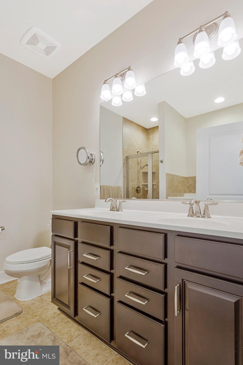 9726 Knowledge Drive Laurel, MD 20723 - Photo 19 of 54 a bathroom with a sink a toilet and a mirror