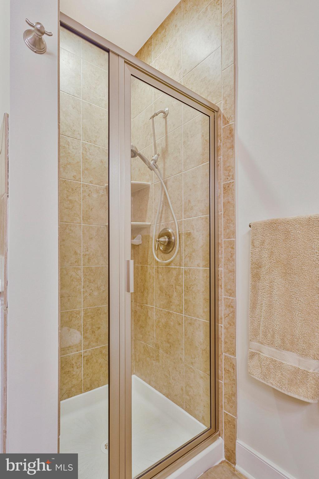 9726 Knowledge Drive Laurel, MD 20723 - Photo 20 of 54 a bathroom with a glass shower door