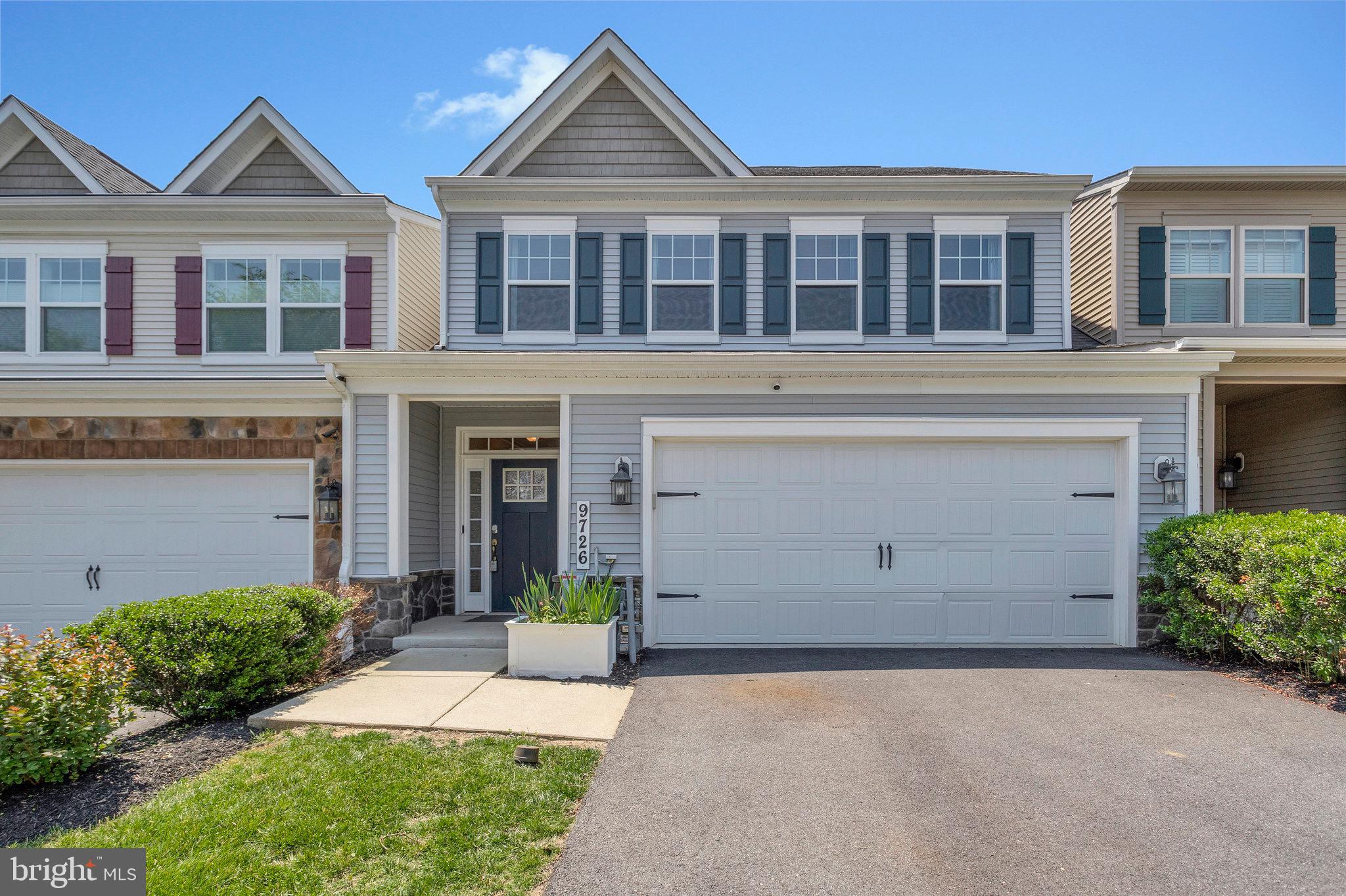 9726 Knowledge Drive Laurel, MD 20723 - Photo 2 of 54 front view of a brick house with a yard