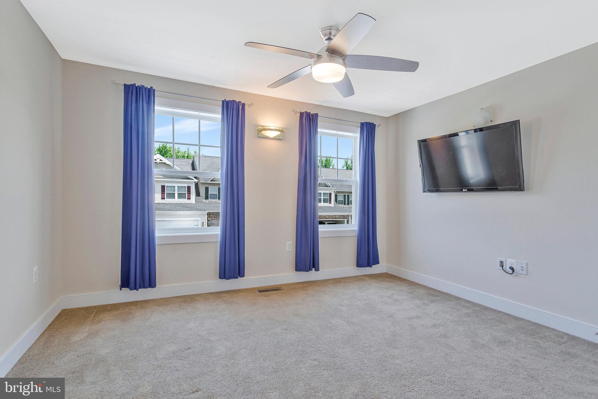 9726 Knowledge Drive Laurel, MD 20723 - Photo 23 of 54 an empty room with windows and fan