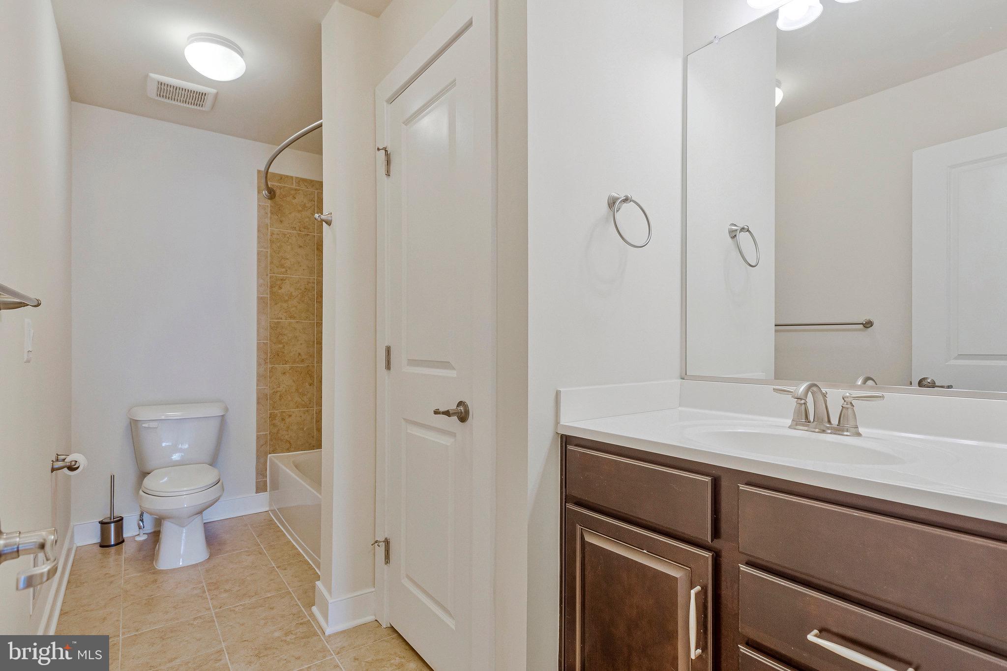9726 Knowledge Drive Laurel, MD 20723 - Photo 25 of 54 a bathroom with a sink a toilet and shower