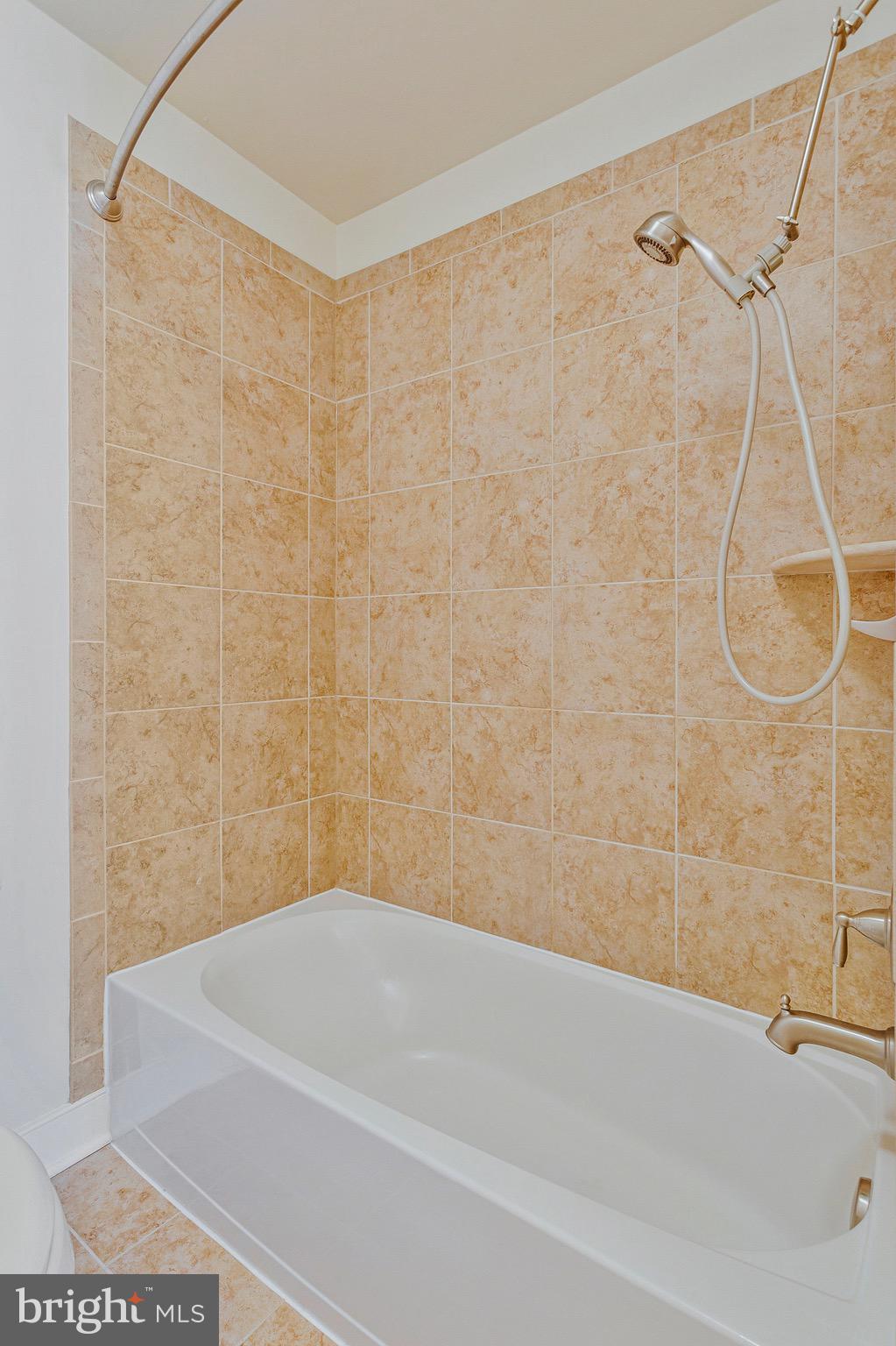 9726 Knowledge Drive Laurel, MD 20723 - Photo 27 of 54 a bathroom with a shower and a bath tub